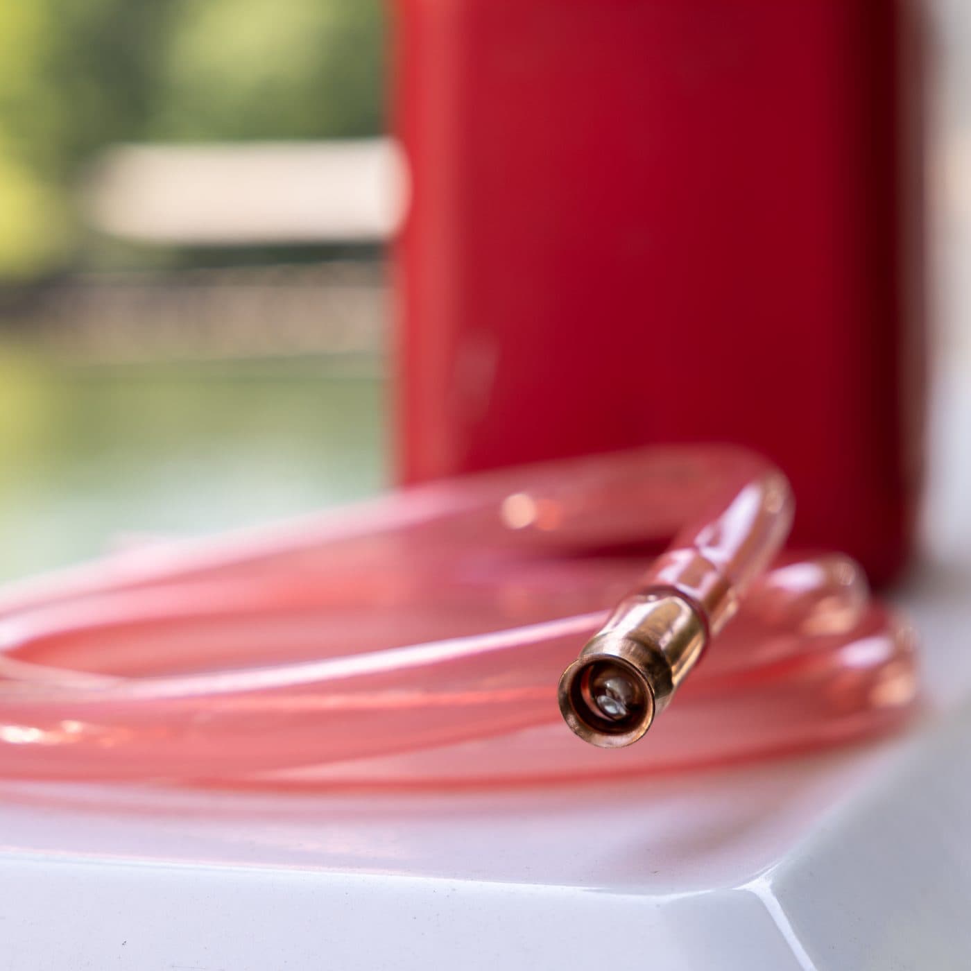FlowPro — ¾" ID × 8' Self-Priming Siphon beside a gas can on a boat